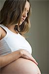 Woman caressing pregnant belly