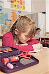 Schoolgirl writing in notebook, Munich, Bavaria, Germany