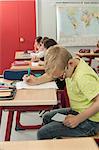 Schoolboy cheating on a test in classroom, Munich, Bavaria, Germany