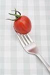 Close up of cherry tomato on fork