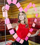 Businesswomen making heart with notes