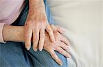 Close up of older woman's folded hands