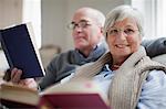 Smiling older couple reading books