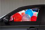 Car filled with colorful balloons