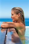 Woman relaxing on side of pool