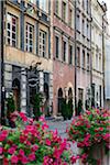 Street scene with old buildings and restaurant sign, Old Town, Warsaw, Poland.