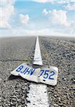 Low Angle View of Bent License Plate on Divided Highway