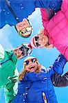 Low angle view of family in winter clothing and sunglasses