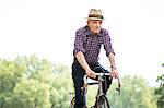 Senior man cycling in park
