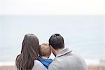 Young family looking at sea view, rear view