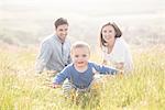 Portrait of young family in field