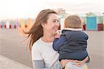 Mother holding young son at beach