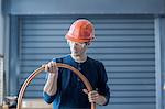 Factory engineer inspecting power cable