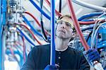 Factory technician checking network cables