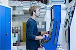 Factory technician working on control panel