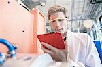 Factory technician using digital tablet