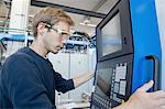 Factory technician working on control panel