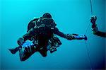 Underwater view of technical diver using a rebreather device to locate shipwreck, Lombok, Indonesia