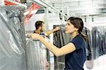 Warehouse workers preparing garment orders in distribution warehouse