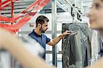 Warehouse workers collecting garment orders in distribution warehouse