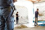 Security guard watching workers in air freight warehouse