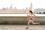 Female runner running on Southbank, London, UK