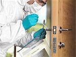 Forensic officer taking DNA swab off door handle