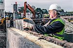 Workers laying bricks on construction site