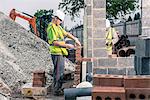 Workers laying bricks on construction site