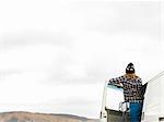 Rear view of young woman looking out from camper van, Point Addis, Anglesea, Victoria, Australia