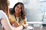 Two teenage girls working together in class