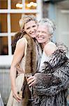 Elegant mature women enjoying champagne in urban garden