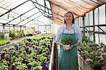 Female gardener in greenhouse