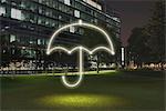 Glowing umbrella symbol in city at night