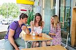 Group of friends sitting in restaurant outdoors