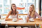 Two women have a cup of coffee in restaurant