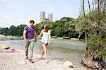 Young couple walking on the riverbank