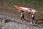 Female surfers carrying surfboard