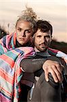 Couple resting on beach, portrait