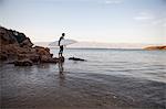 Surfer looking out on sea