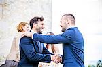 Bridegroom shaking hands with friend