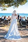 Rear view of bride at wedding ceremony on beach