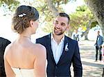 Bride and bridegroom talking outdoors