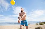 Young man playing beach volleyball