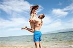 Happy young couple on beach fooling around