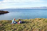 Young couple having a picnic on water's edge