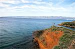 Young couple on cliff overlooking sea