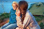 Two women at campsite talking