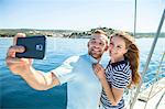 Couple photographing themselves on sailboat, Adriatic Sea