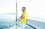 Man standing arms crossed on sailboat, Adriatic Sea